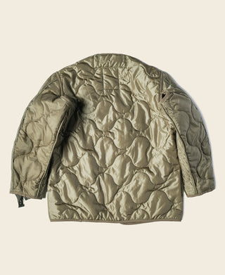 Olive quilted jacket liner, back view with smooth yoke and elastic hem