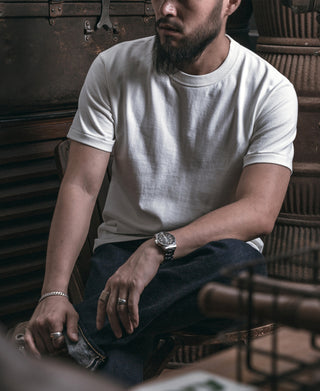 White crew-neck athletic t-shirt with short sleeves, draped over the torso