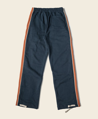 Navy cotton-terry straight-leg sweatpants with rust side stripe and elastic waistband