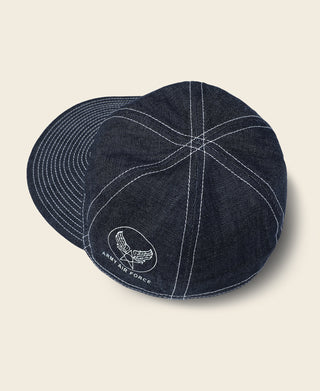 Indigo denim A-3 style cap with round emblem on side and stitched star pattern