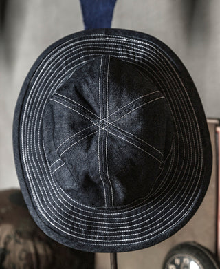 Indigo denim bucket hat with detailed seams and striped stitching around the brim