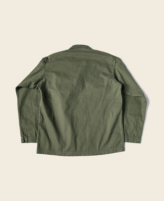 Olive green HBT jacket back view with buttoned yoke and side pockets