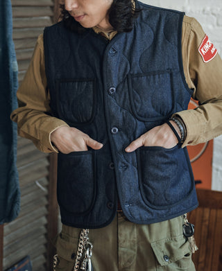 Navy padded denim vest with button placket and two chest flap pockets
