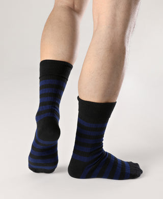 Pair of black and blue striped cotton crew socks on legs