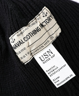 Black knit watch cap with front woven label and U.S.N. tag