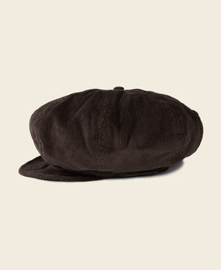 Dark brown corduroy newsboy cap, low-profile crown with smooth stitched texture