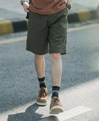 Olive bermuda shorts on model, mid-thigh length