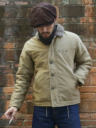 Dark brown corduroy newsboy cap with gathered crown stitching and curved brim