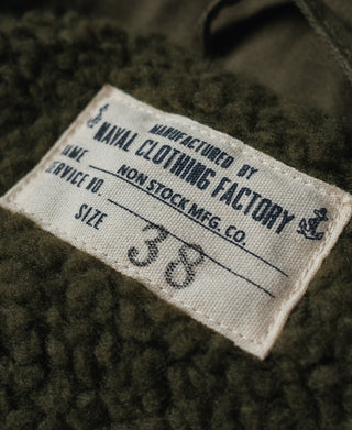 Olive fabric care label with size 38 text