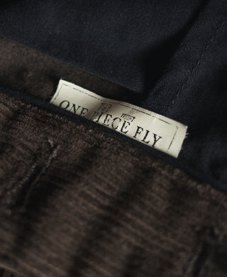 Corduroy pants interior with sewn brand label on waistband.