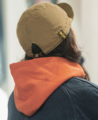 Khaki-olive reversible nylon cap with side label patch and adjustable strap