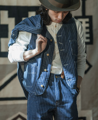 Indigo pinstripe sleeveless work vest with metal front buttons and chest pocket