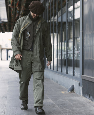Olive M-43 field trousers on person, full length with cuffed hem and cargo pockets