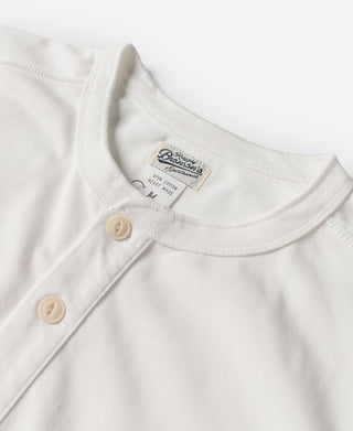 White henley neckline with three buttons and short sleeves, close-up