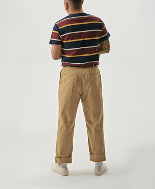 Yellow pleated chino trousers shown from the back with cuffed hems