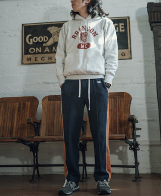 Navy cotton sweatpants with rust side stripe and elastic waistband, cuffed hem