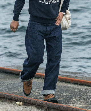 Dark navy denim pants with five-pocket styling and cuffed hems