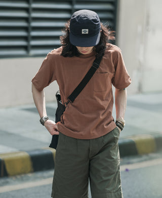 Navy 5-panel cotton cap on a person, with short brim and front logo patch