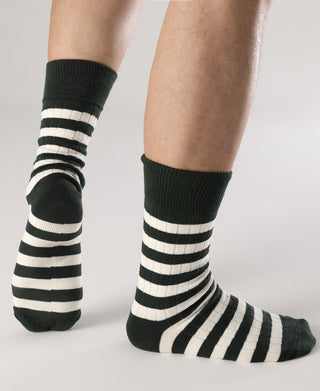 Pair of green and white striped crew socks on model's legs