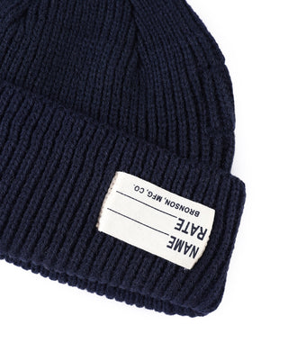 Navy knit watch cap beanie cuff label with brand text