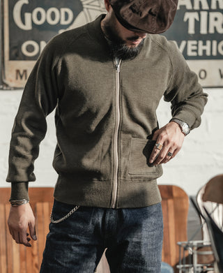 Olive wool zip-up sweater with front pocket and ribbed hem