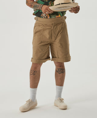 Khaki bermuda shorts on model with front pleats and belt loops