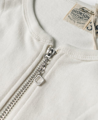 White quarter-zip raglan t-shirt neckline with metal zipper and brand tag