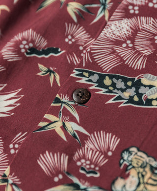 Wine red shirt close-up showing button and tiger-crane pattern with fan and bamboo motifs