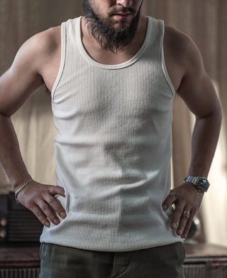 White ribbed cotton tank top on model, scoop neck and classic armholes