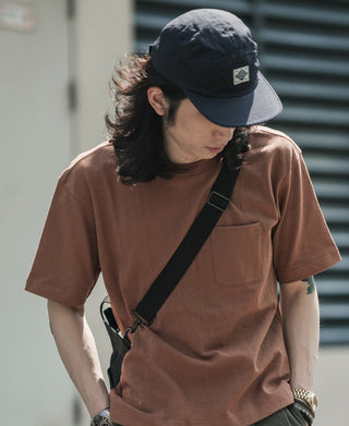 Navy 5-panel cotton cap worn forward, with front logo patch and curved brim
