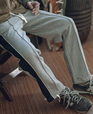 Gray cotton-terry sweatpants with side stripes and adjustable drawstring waist