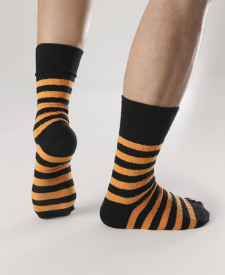Black crew socks with orange stripes and cushioned toe and heel.