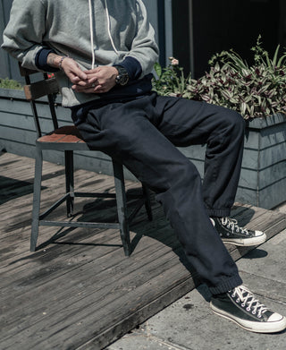 Black terry sweatpants with relaxed fit and elastic ankle cuffs