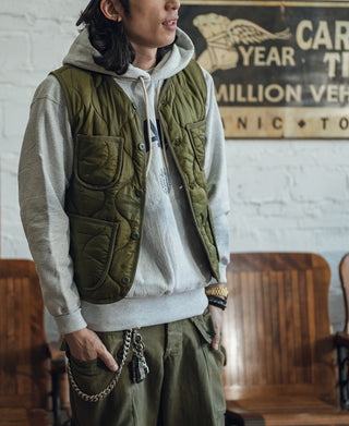 Olive quilted padded nylon vest with front patch pockets and snap closure