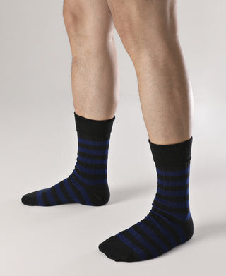 Black and blue striped cotton crew socks on feet