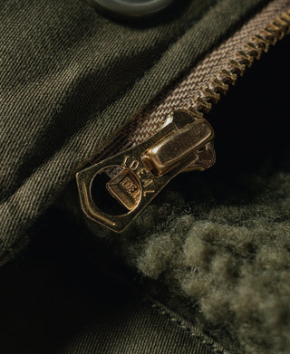 Olive deck jacket strap with metal buckle and decorative trim