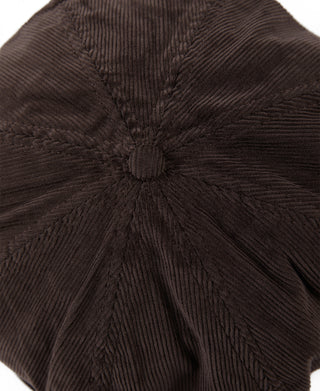 Dark brown corduroy cap close-up, gathered crown with center button detail