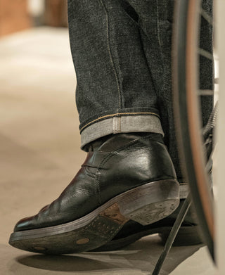 Indigo selvedge denim jeans close-up at hem with selvedge edge visible
