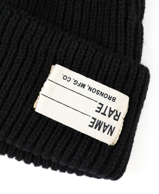 Black knit watch cap with woven brand label on cuff