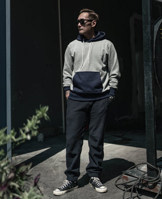 Black terry sweatpants with drawstring waistband and tapered jogger legs
