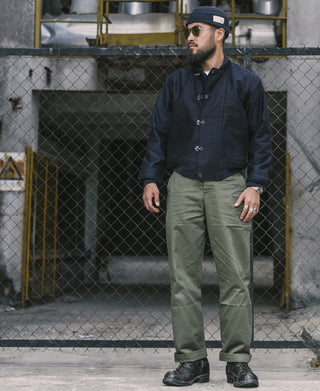 Olive M-43 field trousers on person, full front view with belt loops and straight fit