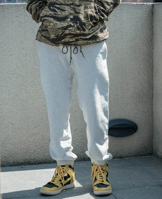Light gray sweatpants with drawstring waistband and ribbed ankle cuffs
