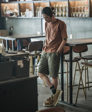 Olive bermuda shorts with front button closure and utility pockets