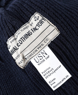 Navy knit watch cap beanie close-up of white fabric label