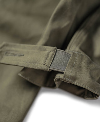 Olive parka sleeve cuff with fabric tab and snap strap detail