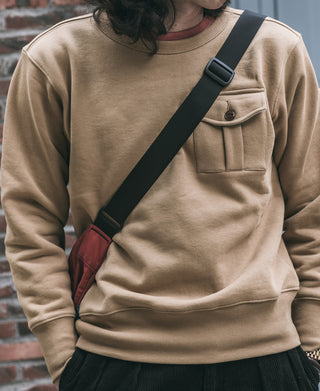 Khaki crewneck sweatshirt with chest pocket and ribbed cuffs, worn front view