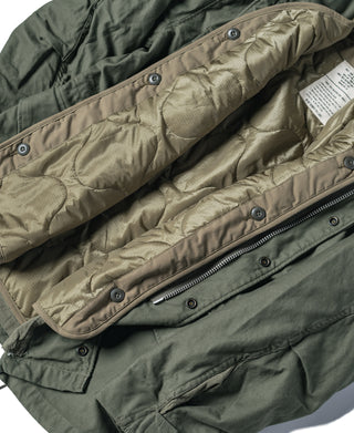Olive quilted liner with diagonal button placket and zippered inner pocket