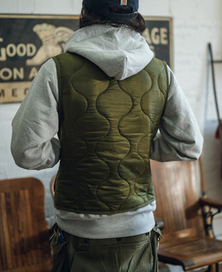 Olive quilted padded nylon vest back view with wavy stitched pattern