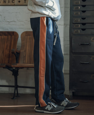 Navy straight-leg sweatpants with rust side stripe and adjustable drawstring waist
