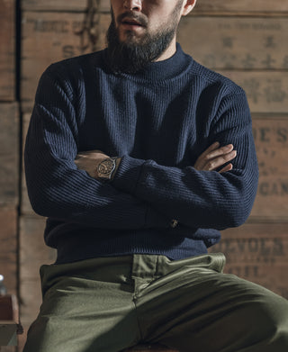 Navy crewneck wool sweater on model, ribbed cuffs and neckline